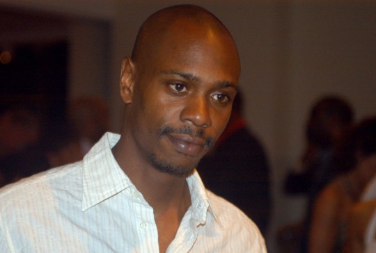 Inb a May 5, 2006 file photo comedian Dave Chappelle attends a reception at the Muhammad Ali Center in Louisville, Ky.  Chappelle decided to sit out most of his show in Hartford Thursday, Aiug. 29, 2013, because of a noisy audience. (AP Photo/Brian Bohannon, file)